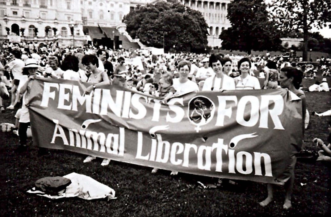 The Feminists for Animal Liberation banner for the 1990 March on Washington. In the center are Batya Bauman, Carol Adams, and Marti Kheel. Photograph © by Bruce A. Buchanan. Used without permission.