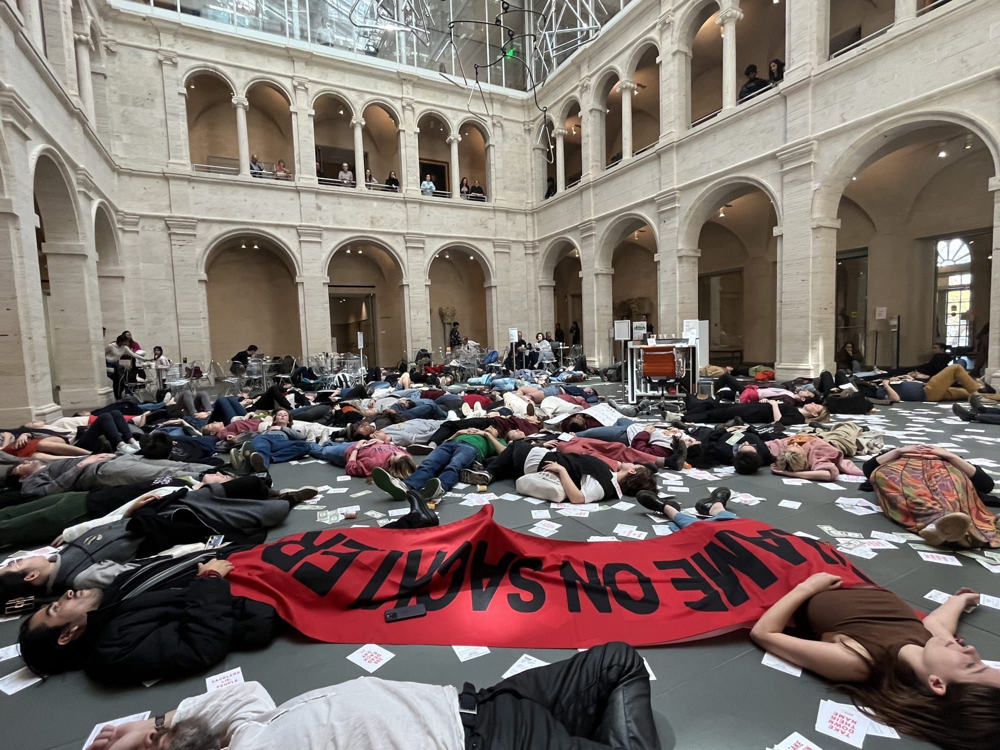 Harvard University students staging a die-in at the school’s Arthur M. Sackler Museum @harvardartmuseums, 2023.