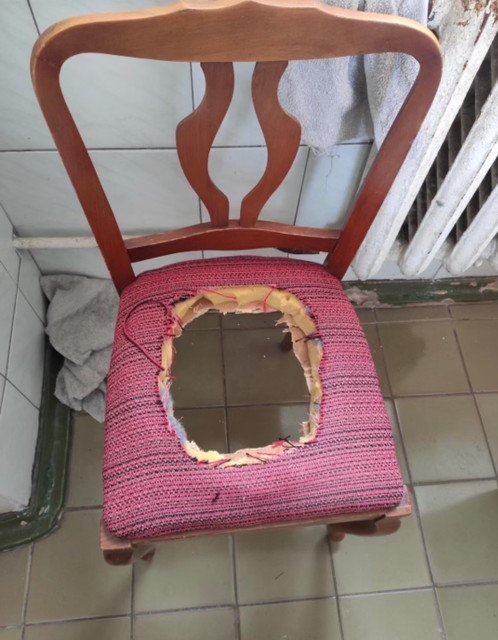 A chair at one of the state enterprises in Chernobyl that were occupied and looted: Russian troops cut a hole in it and used it as a toilet, leaving excrement in the office.