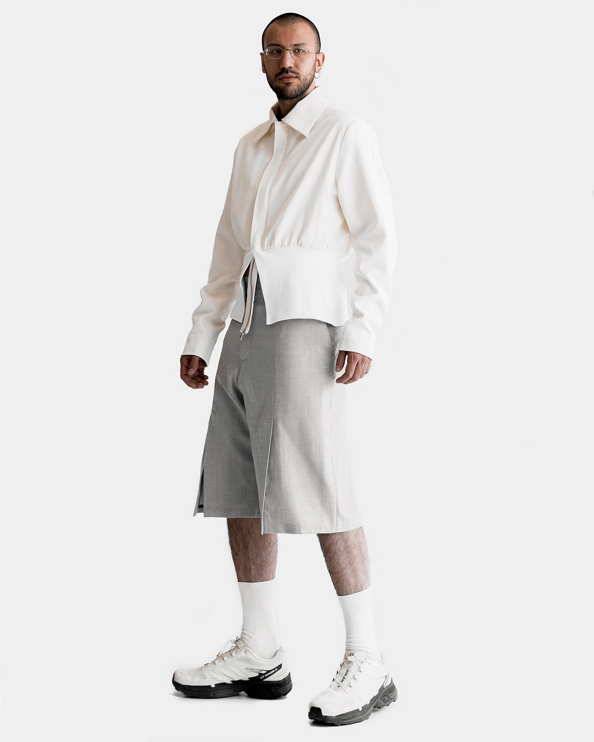 Vagan is wearing a milk white zipped GUIDE jacket and woolen slashed FRIEND shorts by Ruslan Nasir