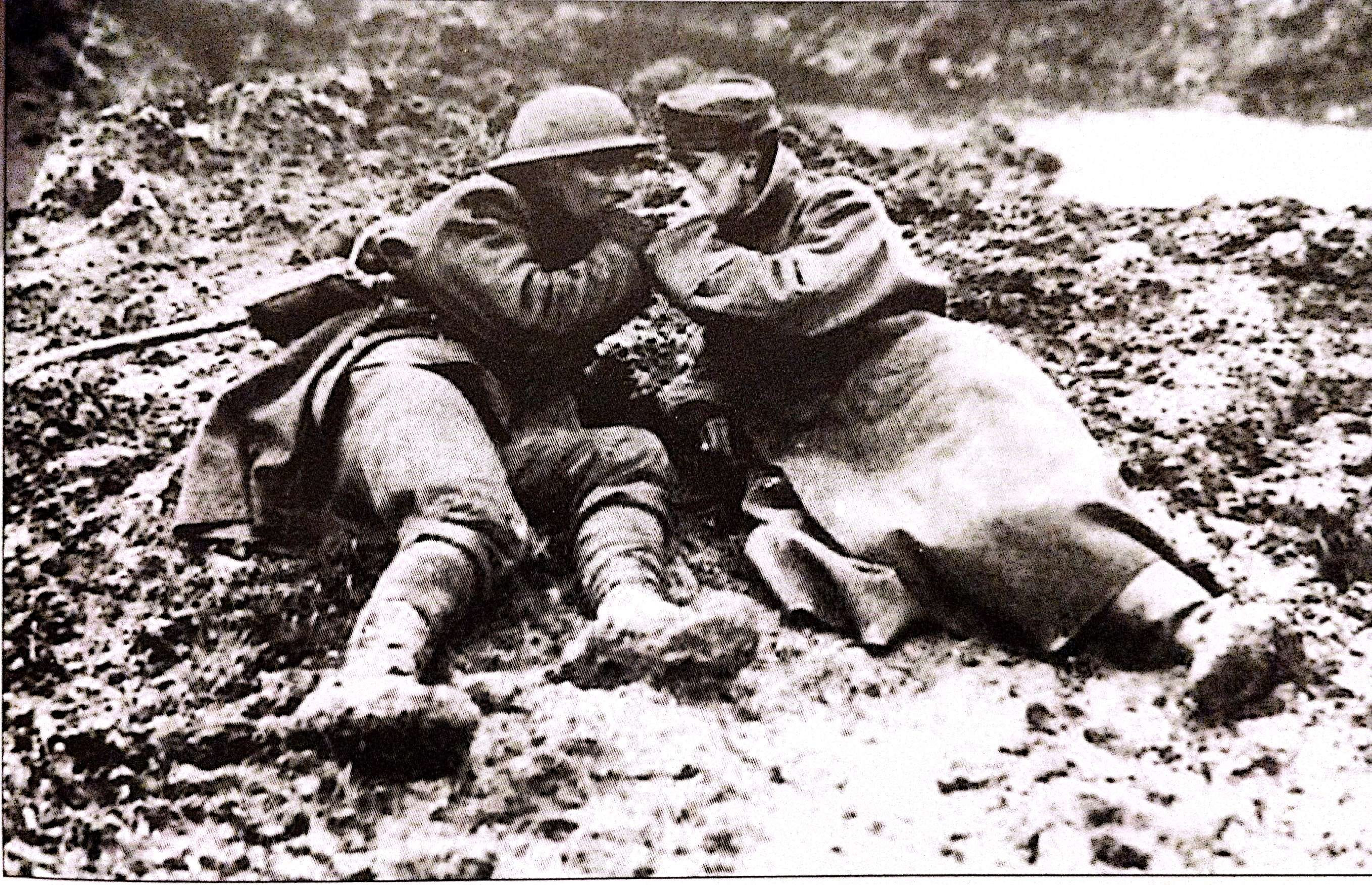 A Canadian soldier and his German captive share a light amid the endless mud and shellholes of Flanders.