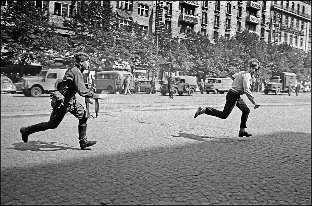 Ian Berry. Czechoslovakia. Prague. A Russian soldier chases a Czech man in Wenceslas Square. 1968