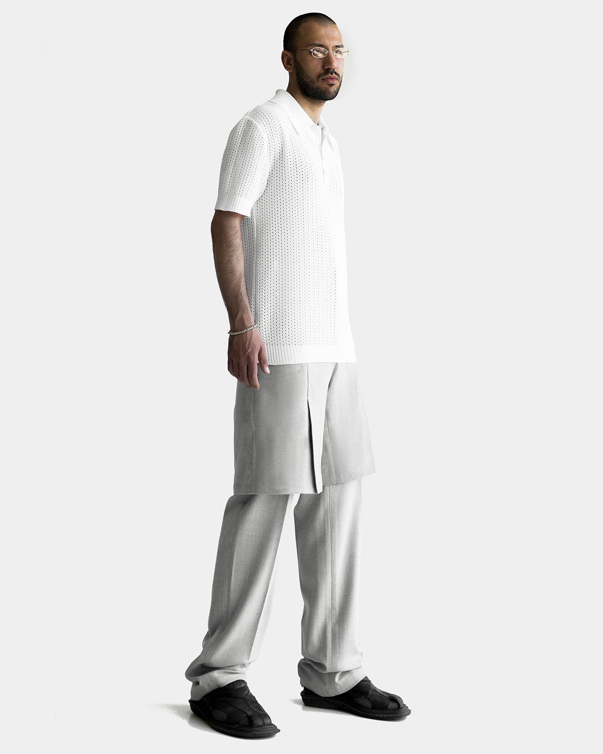 Vagan is wearing a white knitted BROTHER polo-shirt and grey woolen FRIEND shorts-trousers by Ruslan Nasir